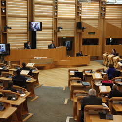 A photo of the scottish parliament chamber with members in their seats