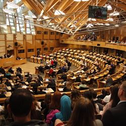 An image of the scottish parliament chamber with a view from the public gallery