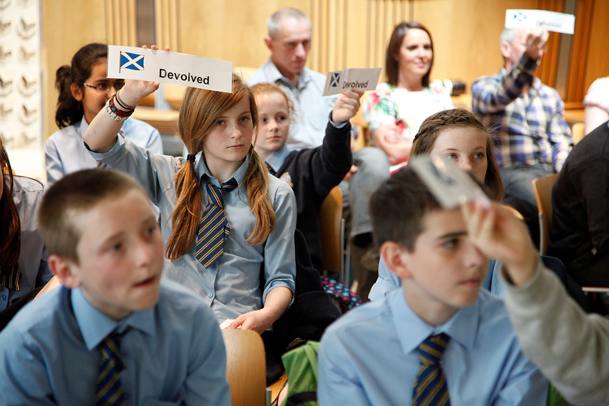 Schoolchildren taking part in a quiz during a visit to the Scottish Parliament