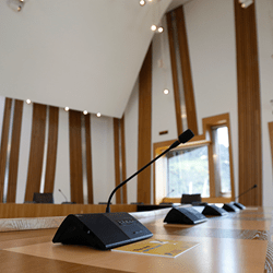 A photo of a microphone in a committee room