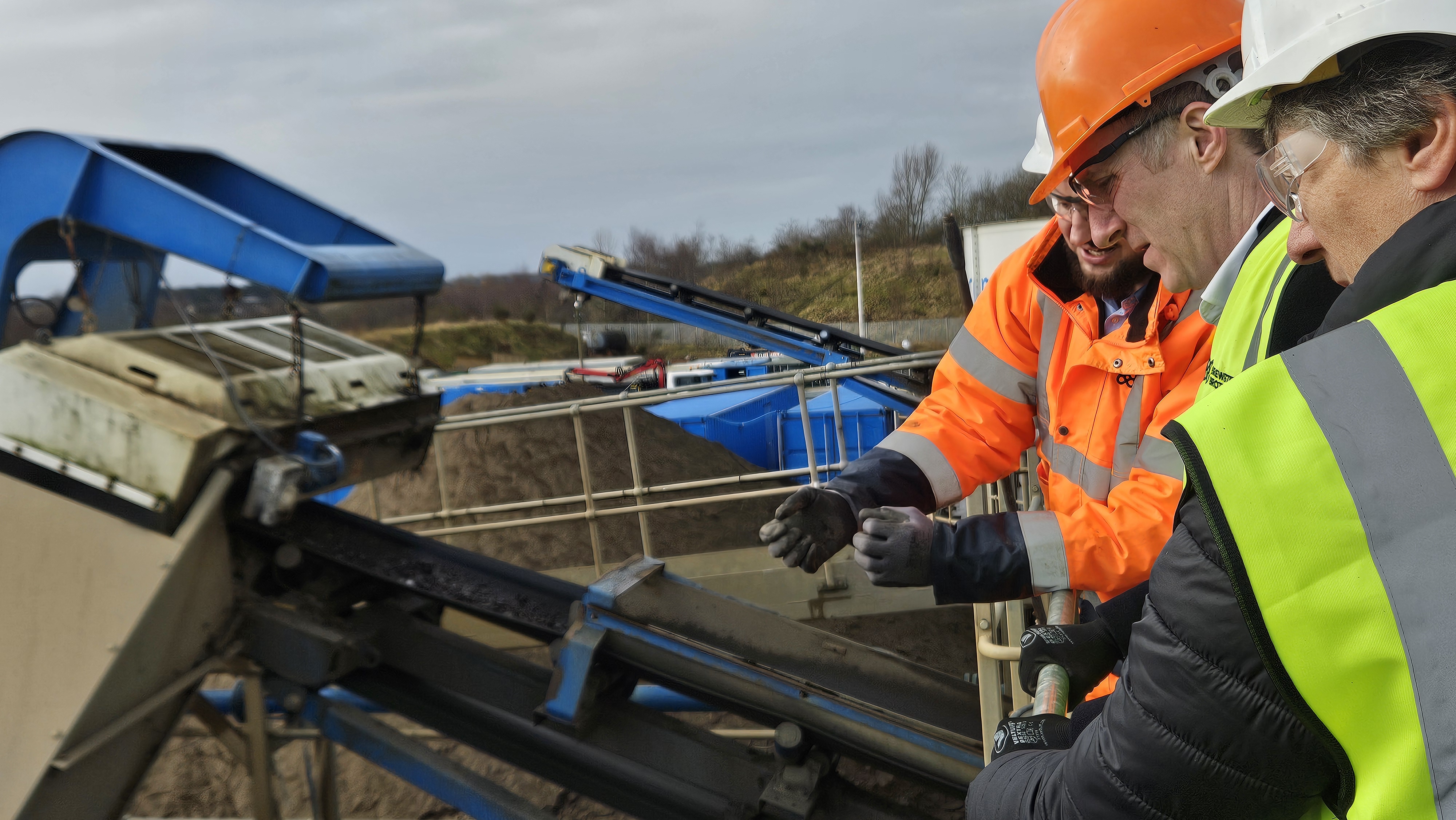Photograph of two Members of the Finance and Public Administration Committee looking at machinery during the fact-finding visit at Brewster Brothers